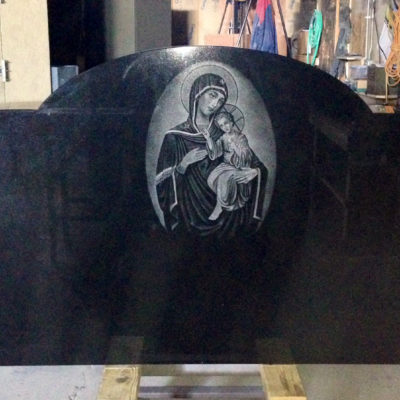Custom etching of Madonna Child on monument